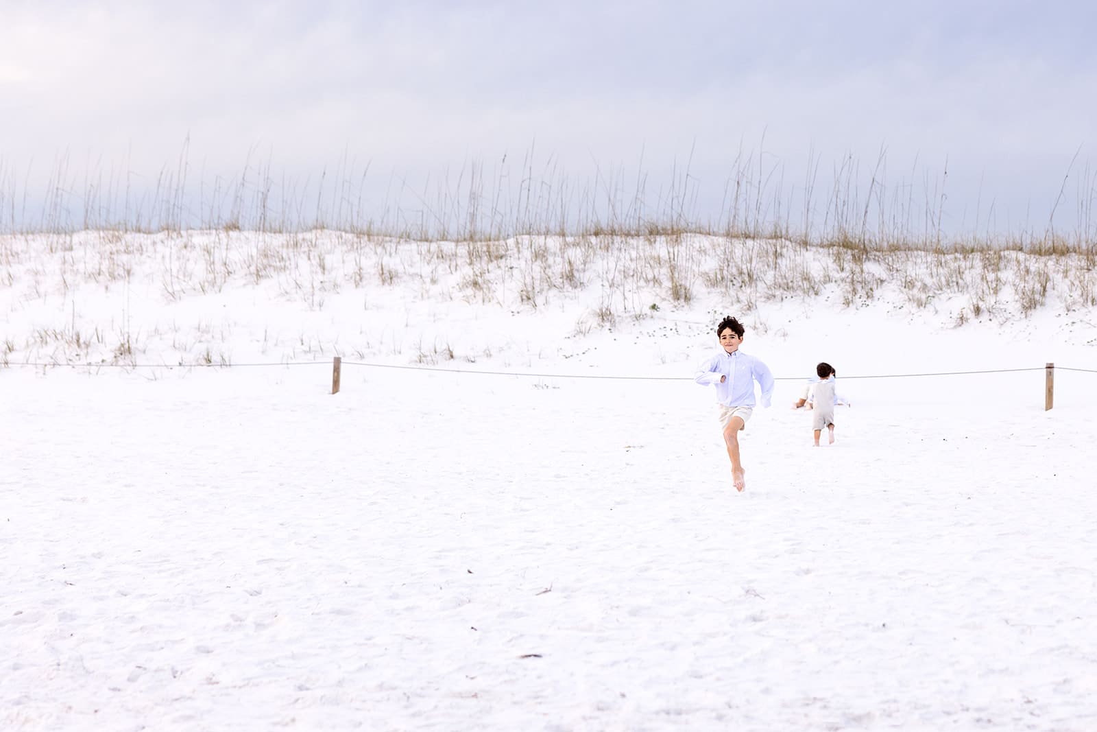 little boys running in the sand in florida