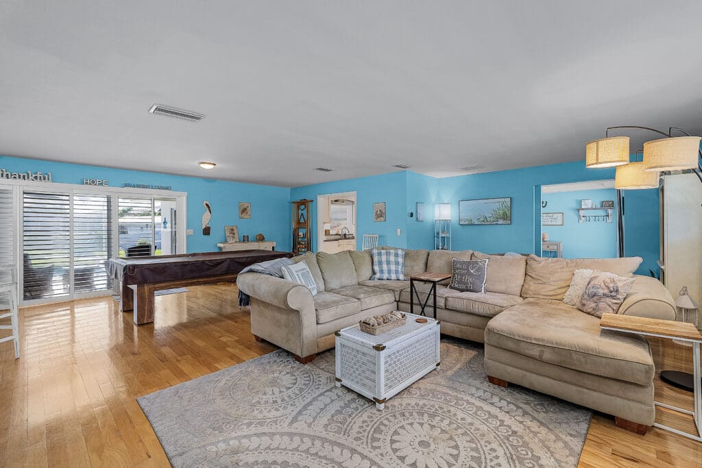 Living room of South Del Prado Point with a sectional & pool table