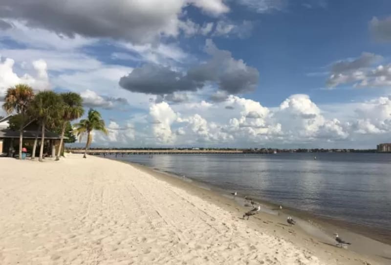 Sandy shoreline and calm water at one of the best beaches near Cape Coral on a quiet day.