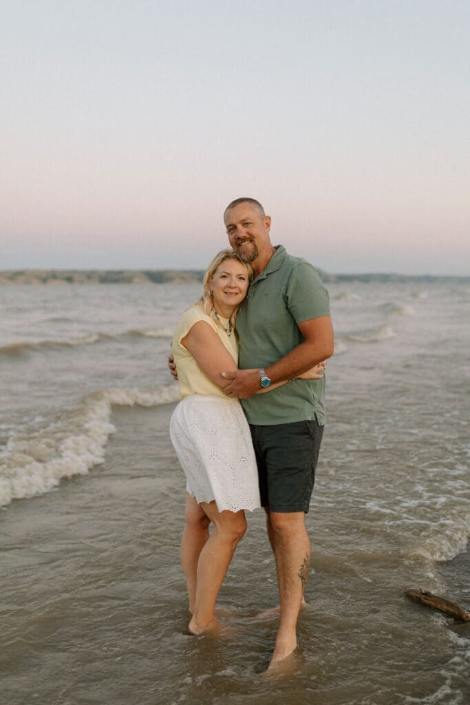 Couple standing on the beach at sunset enjoying the warm Cape Coral climate