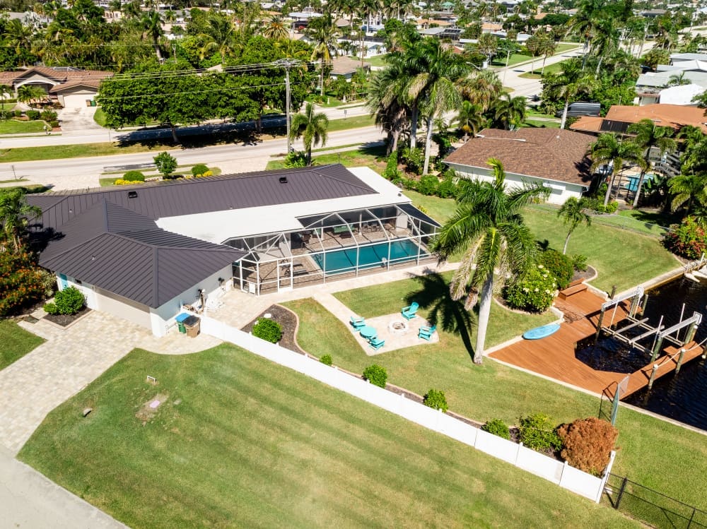 A bird’s-eye view highlights the waterfront vacation home, private dock, heated pool, and spacious backyard nestled along a quiet canal. These are the kinds of Florida vacation ideas that make it easy to spend more time together and less time rushing.