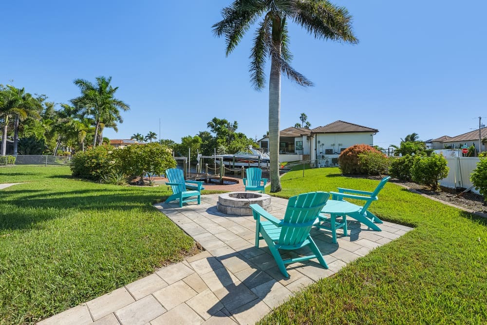 Backyard canal view with palm trees and seating area at one of the best Florida family vacation spots.